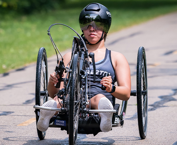 Jacie King riding a hand cycle.