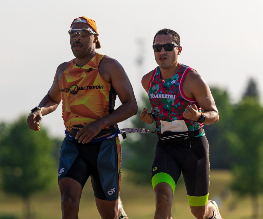 Irwin Ramirez running next to a guide.