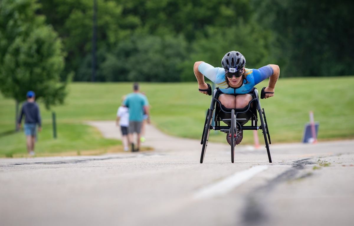Skyler Fisher pushing toward the finish line at the 2024 USA Paratriathlon National Championships.