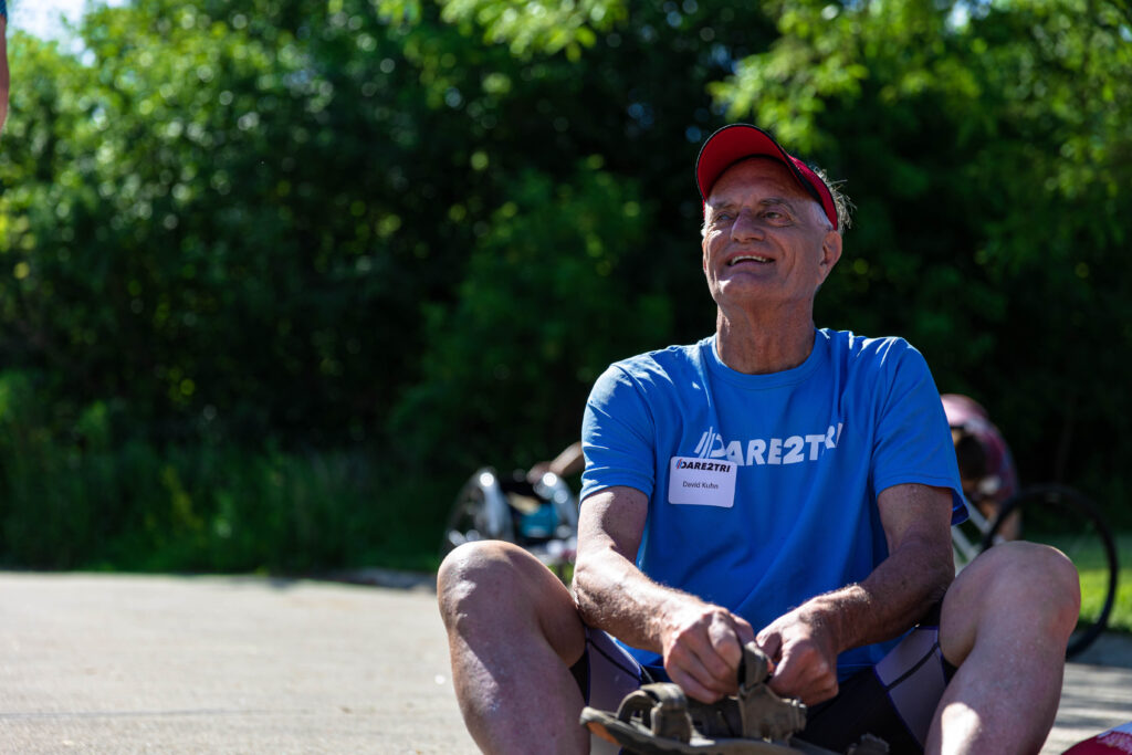 David Kuhn sitting, smiling.