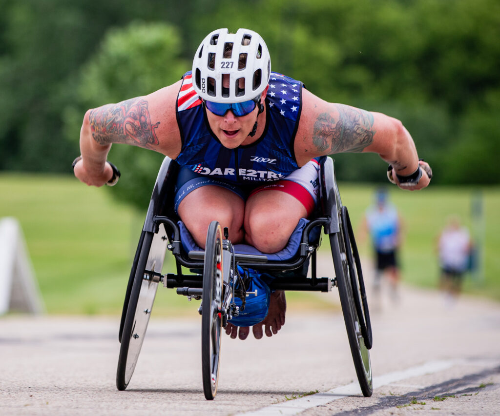 Julius McManus pushing racing wheelchair.